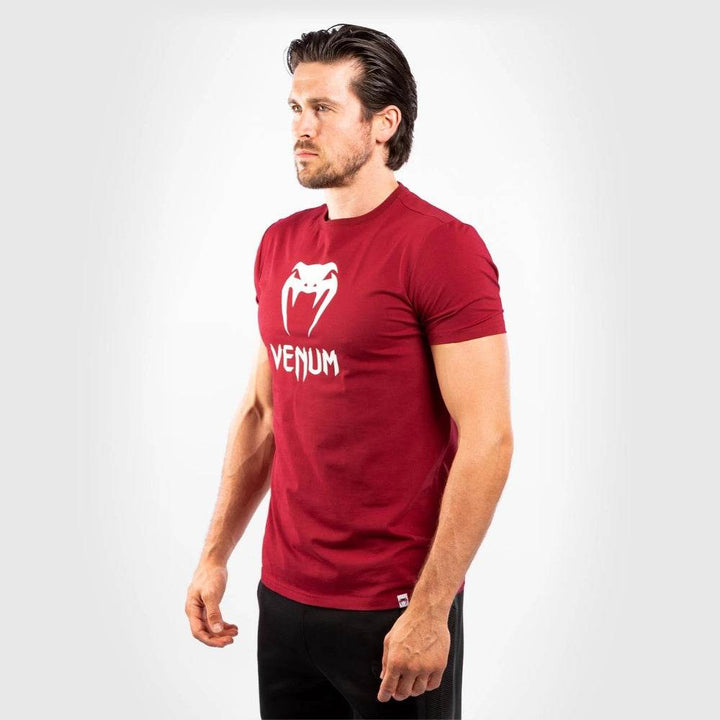 Side view of the man wearing the same red shirt, highlighting the slim athletic fit.