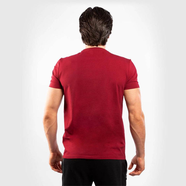Back view of the man in the red t-shirt showing a clean, logo-free design.