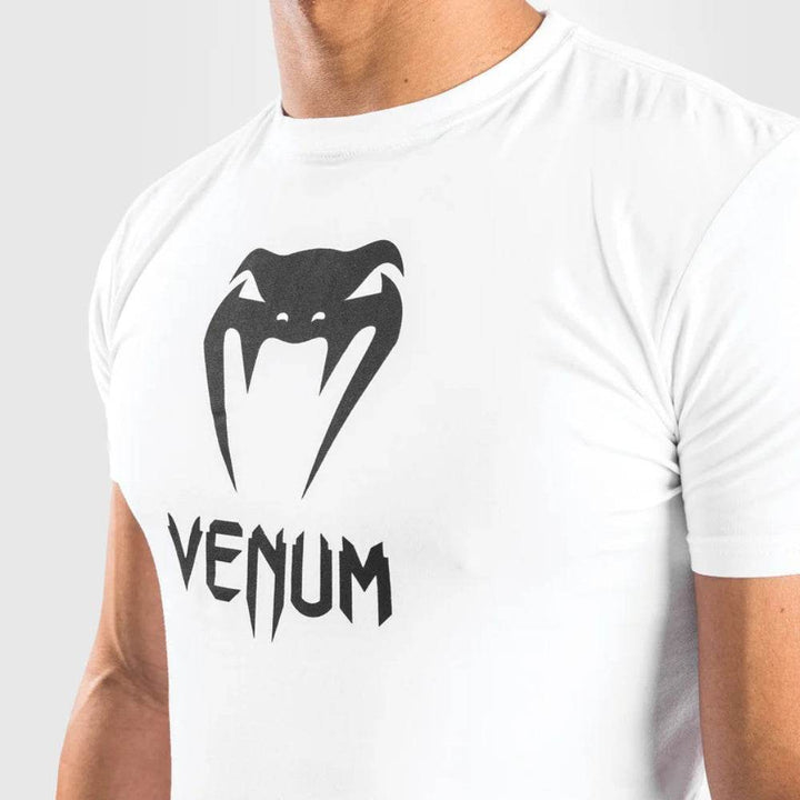 Close-up of the chest area showing the Venum logo print on the white t-shirt.