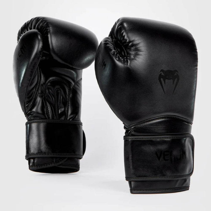 Paired front and angled side view highlighting the stealth all-black aesthetic with black-on-black design elements and a matte finish.