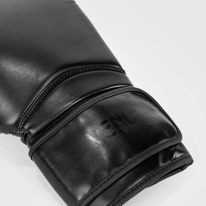 Detailed close-up of the wrist area showing subtle tonal “VENUM” branding and hook-and-loop strap system for secure closure.