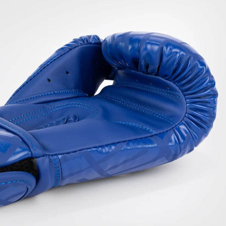 Zoomed-in view of the interior structure showing blue and white graphic wrap, contrast stitching, and snug wrist support.