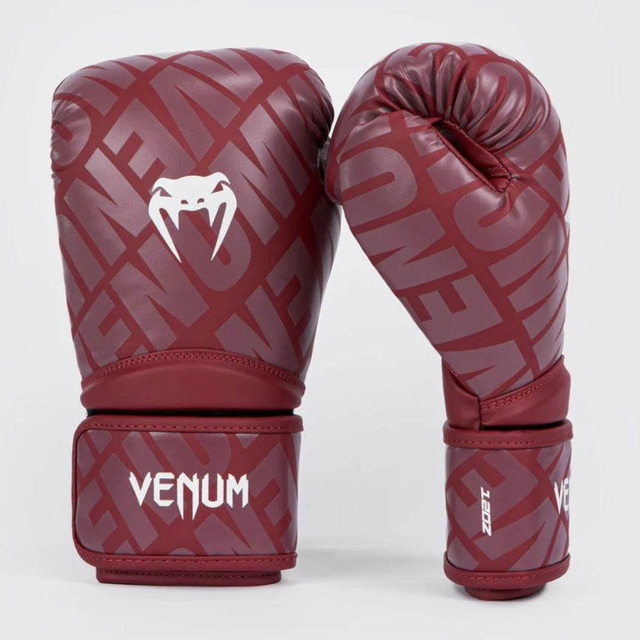 Side profile and front view highlighting the glove’s burgundy print and white wrist cuff with black Venum branding.