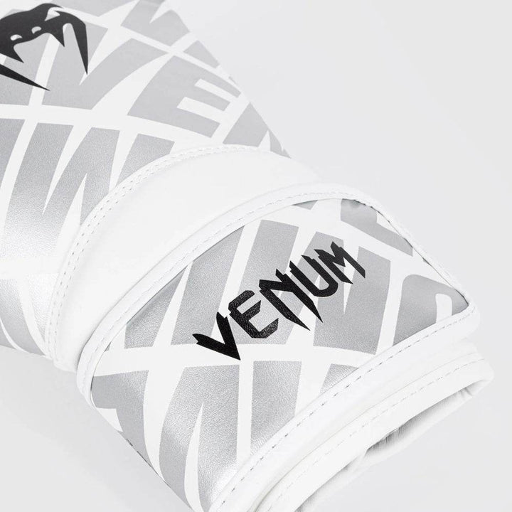 Detailed underside view of the glove’s palm area showing ventilation holes, padded grip bar, and smooth white synthetic leather interior for comfort and breathability.