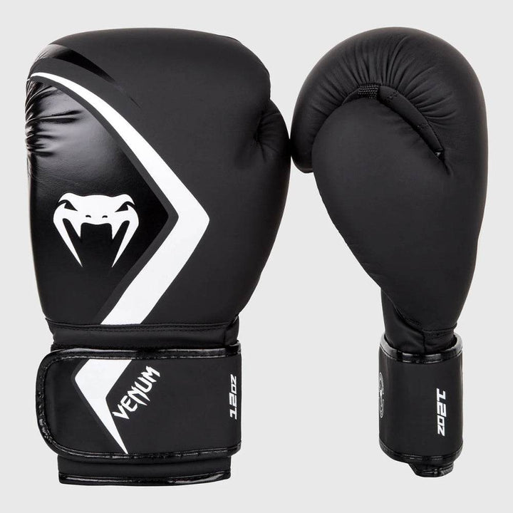 Side-by-side view of Venum Contender 2.0 gloves showing the full front and profile angles, with “12oz” weight marking on the cuff and sleek white branding.