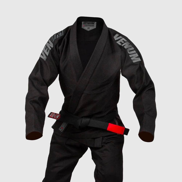 Front angle of the Venum Contender Evo BJJ Gi in black, displayed on an invisible mannequin, showing the embroidered Venum logos on the shoulders and the included black belt with red tip.