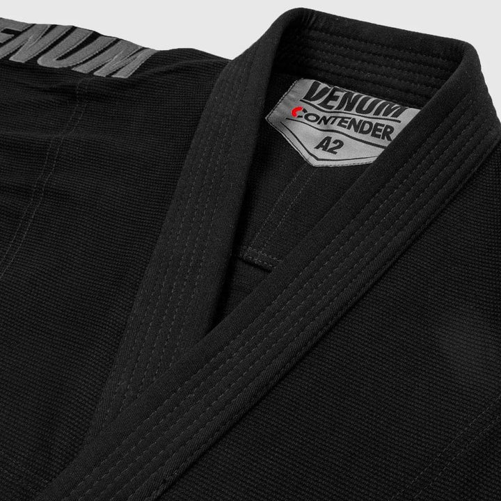 Close-up image of the gi collar, showcasing the thick reinforced lapel and inner Venum Contender A2 label stitching.