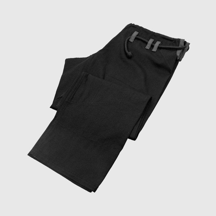 Venum Contender Evo BJJ Gi pants in black shown folded, with visible drawstring loops and reinforced knee panels.