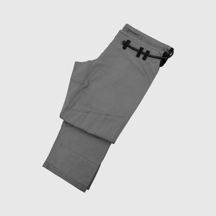 Flat lay of grey Gi pants, showcasing the knee panel seams.