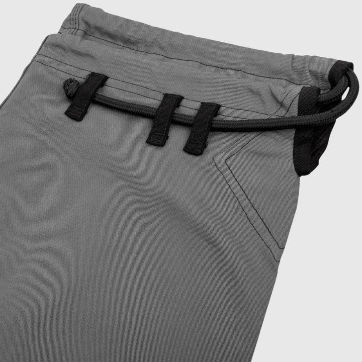 Close-up of waistband loop and drawstring of grey Gi pants.