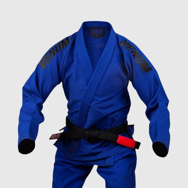 Front view of the blue Venum Contender Evo BJJ Gi on a mannequin, with black VENUM text branding on the shoulders and a black belt with red bar.