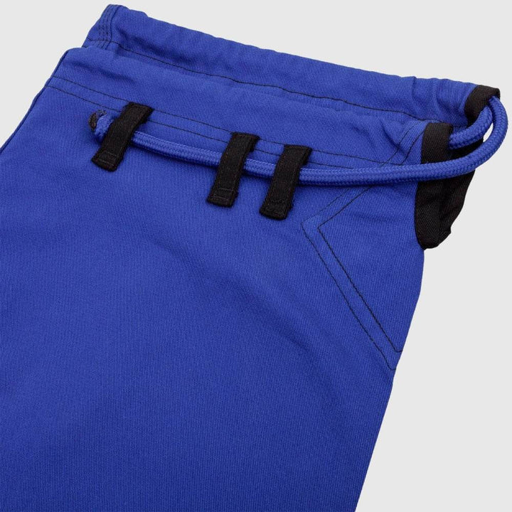 Waistband close-up of the blue gi pants with drawstring and triple belt loops in black.