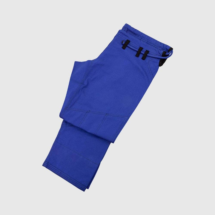 Folded blue gi pants shown from above, displaying the reinforced knee seams and overall build.