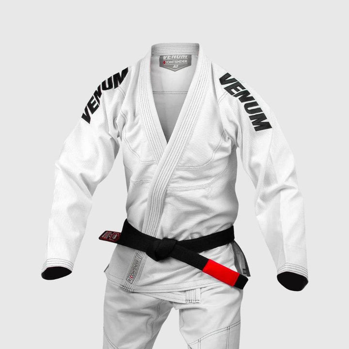 White Venum Contender gi on mannequin with bold black shoulder logos and classic black belt.