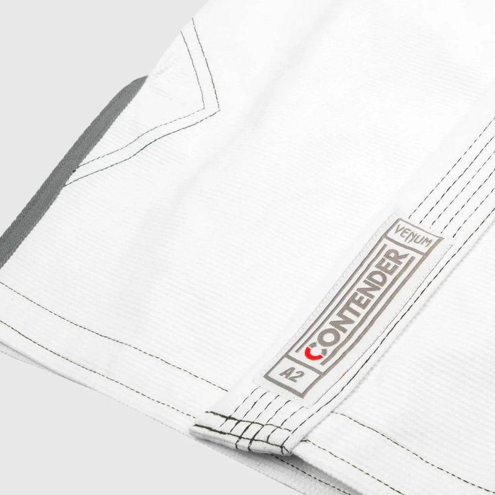 Detailed image of bottom jacket hem with Venum Contender patch and “A2” size marking.