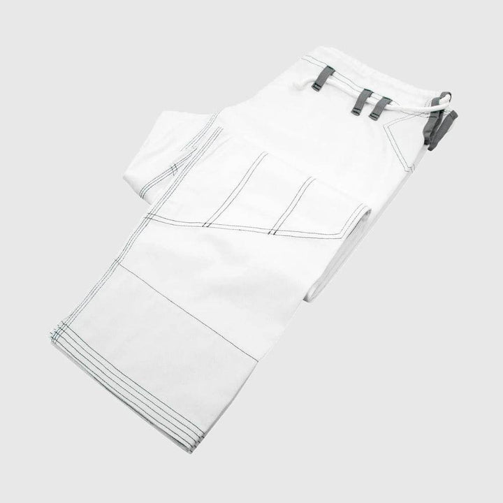 White gi pants laid out flat with visible reinforced stitching and loop system.
