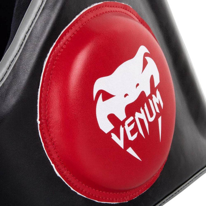 Detailed view of the padded red side target on the Venum Elite Belly Protector with white Venum snakehead logo.