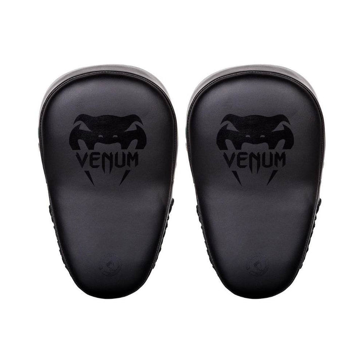 A pair of black Venum focus mitts, showing the front striking surface with the black Venum logo printed prominently.