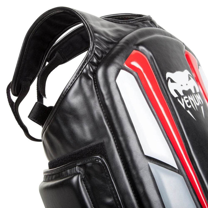 Detailed close-up of the shoulder area on the Venum Elite Body Protector highlighting reinforced stitching and adjustable padded straps.