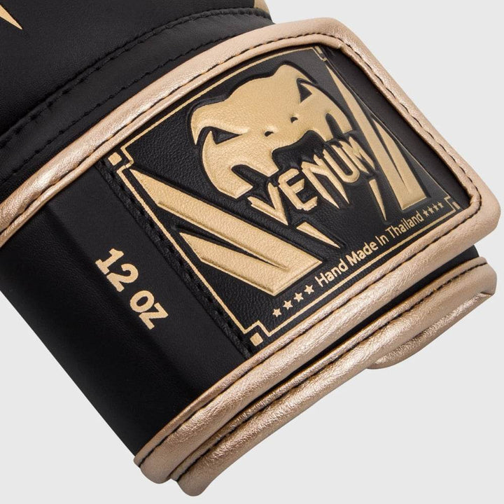 Detailed wrist strap close-up with gold Venum logo patch and black border.