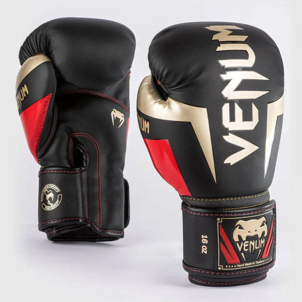Front and palm view of Venum Elite gloves in black, gold, and red with large metallic Venum logo and 16oz label.