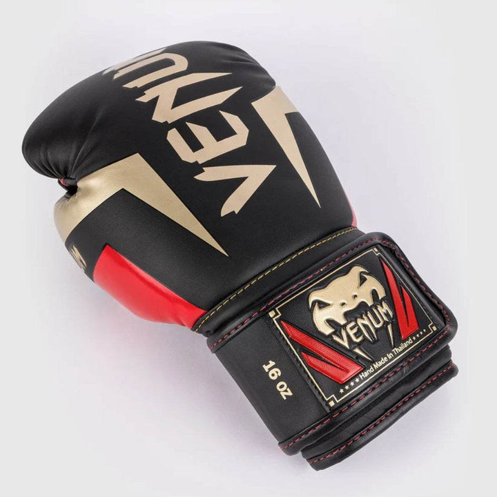 Angled palm view highlighting the thumb protection, wrist reinforcement, and vibrant gold Venum detailing.