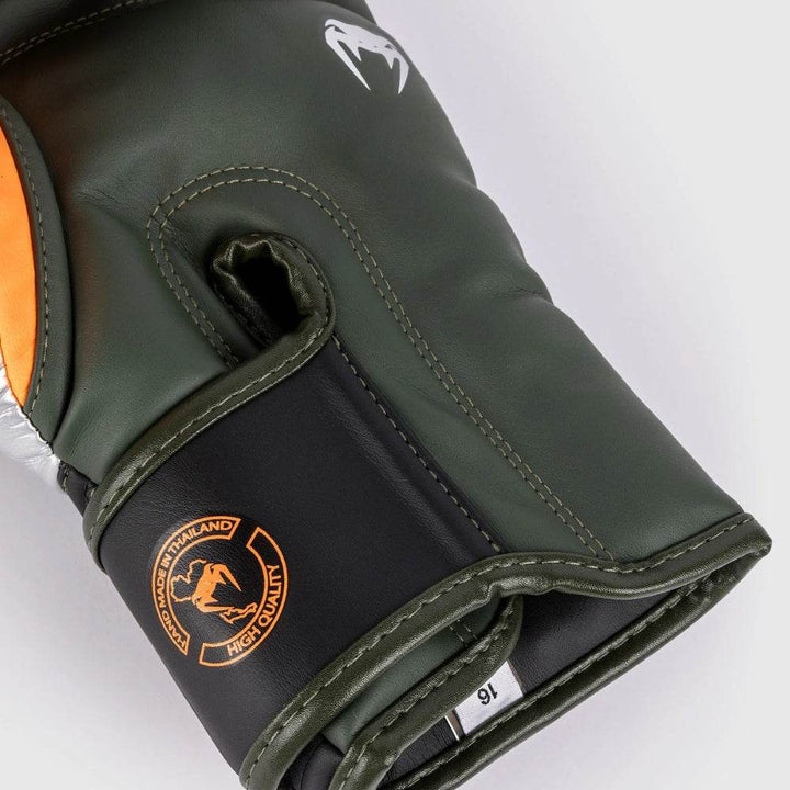 Close-up of the wrist area on a Venum Elite glove showing orange "High Quality" stamp and visible stitching detail.