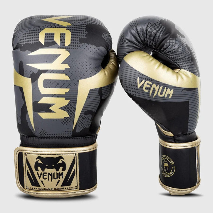 Front and angled side view of the Venum Elite Boxing Gloves in Dark Camo/Gold, showcasing gold Venum branding over a dark camouflage background with golden trim.