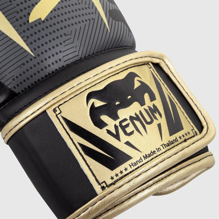 Close-up of the wrist strap area, featuring the embossed Venum snakehead logo and “Hand Made in Thailand” text in gold on a black strap.