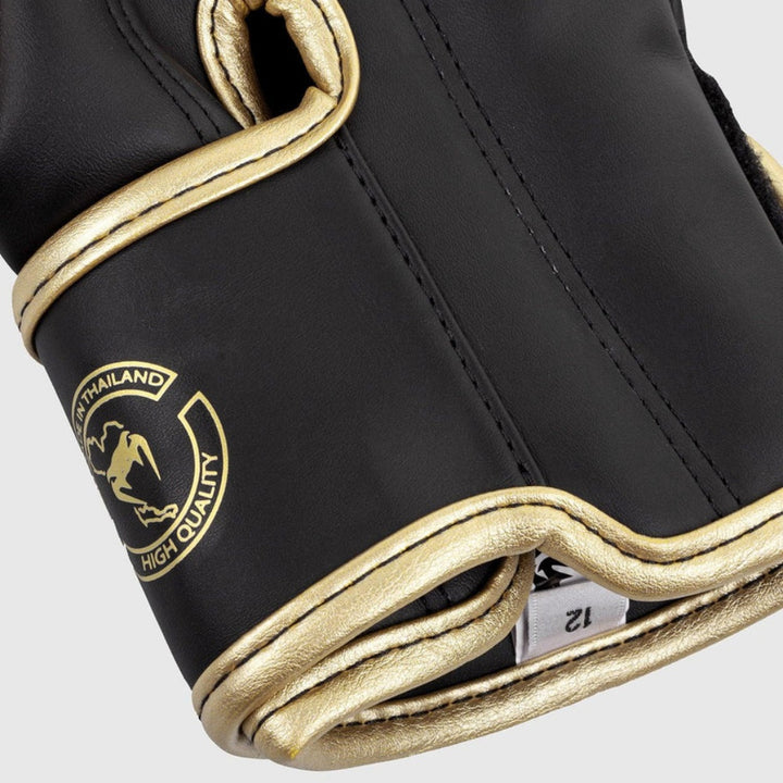 Close-up of the rear wrist strap area, featuring the embossed Venum snakehead logo and “Hand Made in Thailand” text in gold on a black strap.