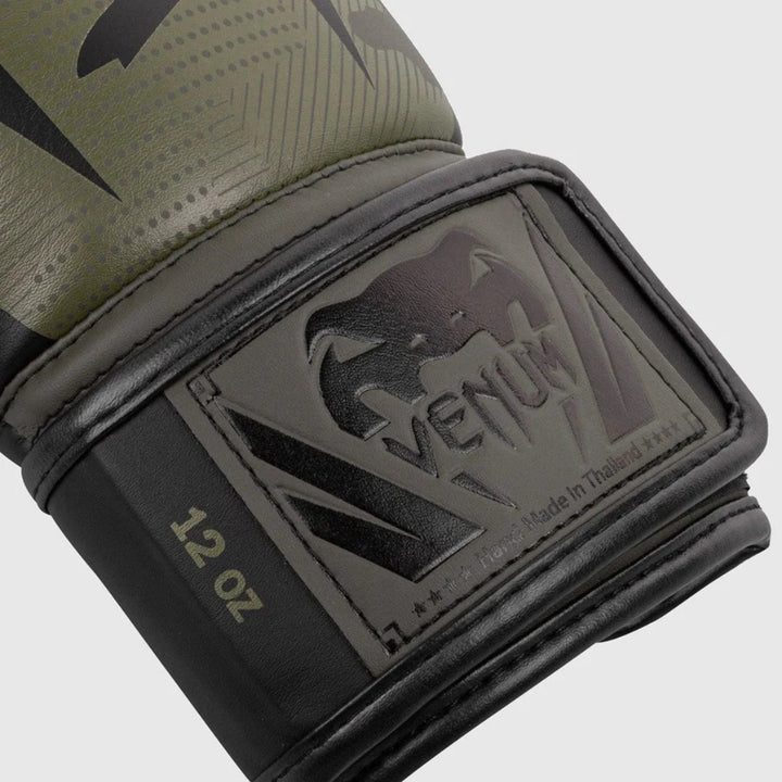 Close-up of the glove’s wrist strap with “Venum” logo patch and gold trim design.