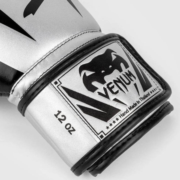 Macro shot of the glove’s wrist area, highlighting the Venum logo patch, “12 OZ” weight label, and stitched design details.