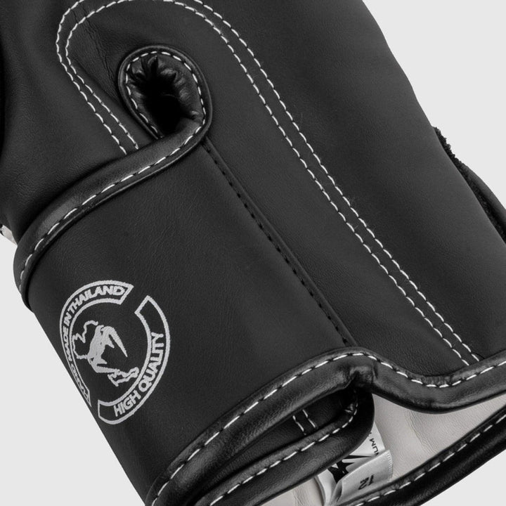 Close-up of the glove's inner wrist area with detailed stitching, black and grey camo edge, and size label visible inside.