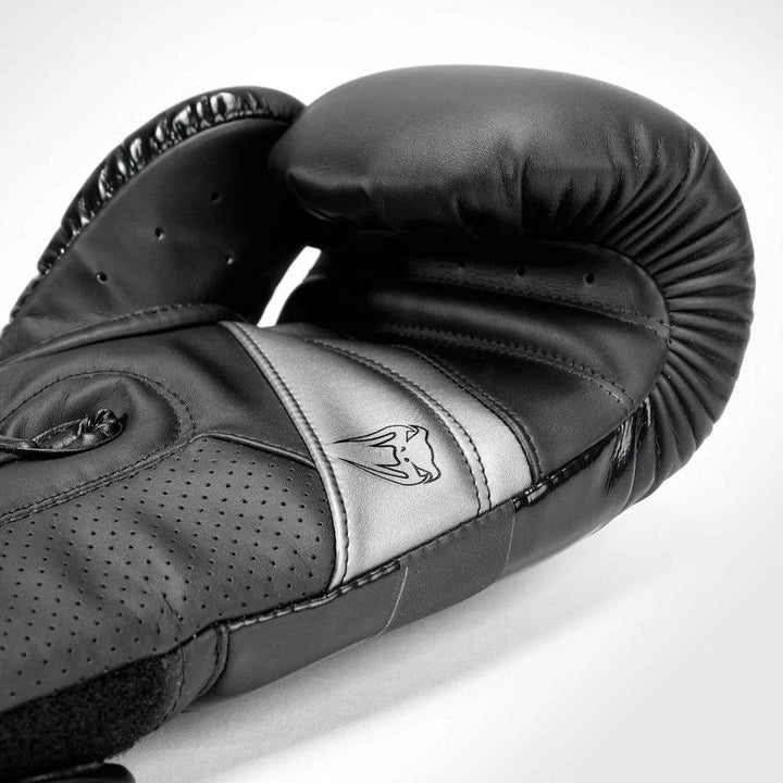 Rear & palm of all-black gloves with stealth branding and black mesh panel.