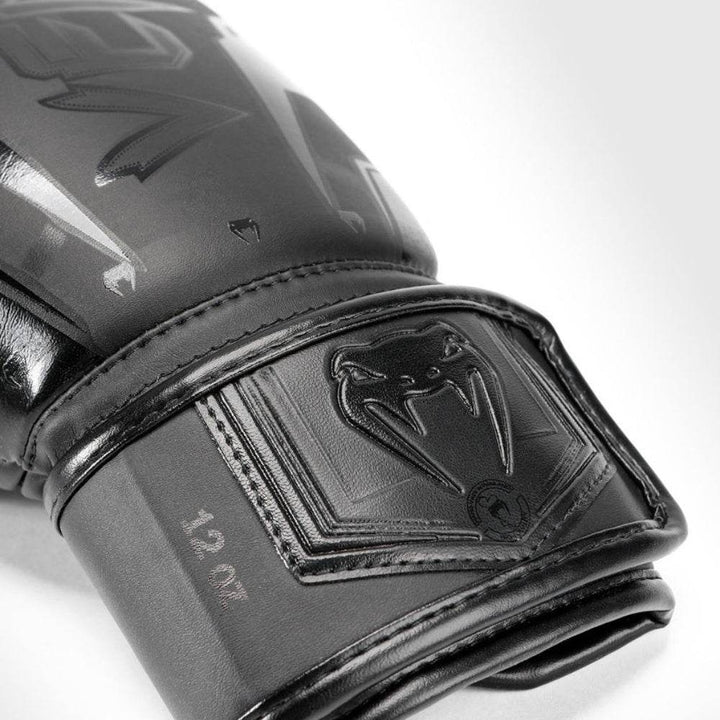 Wrist-strap close-up of embossed black snake patch and tonal stitching.