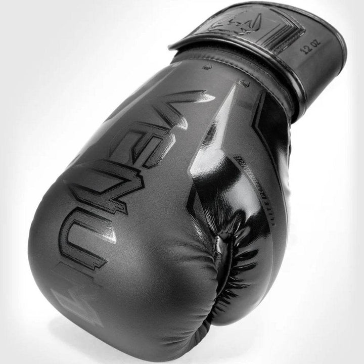 Single black glove on its side highlighting black-on-black logo across knuckles.

