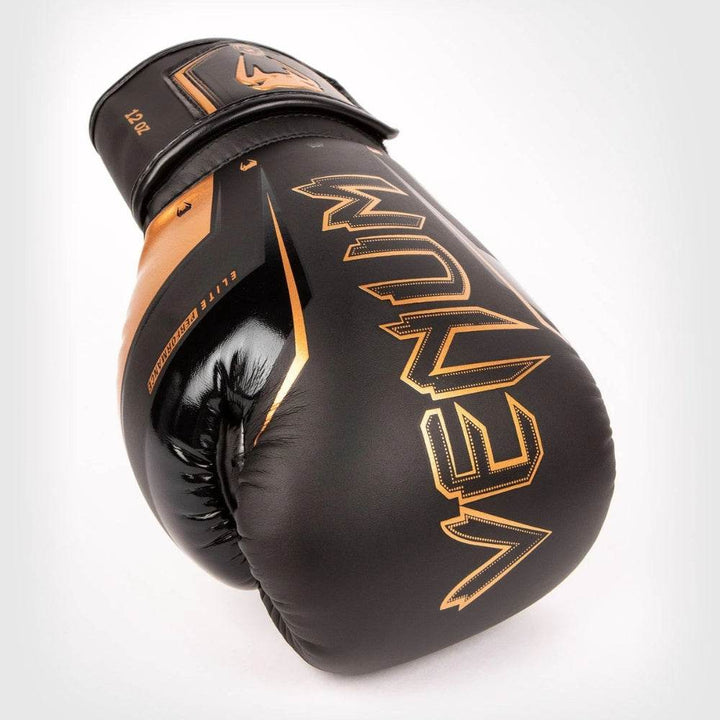 Black-bronze glove laid on side, emphasising bronze “VENUM” text across knuckles.