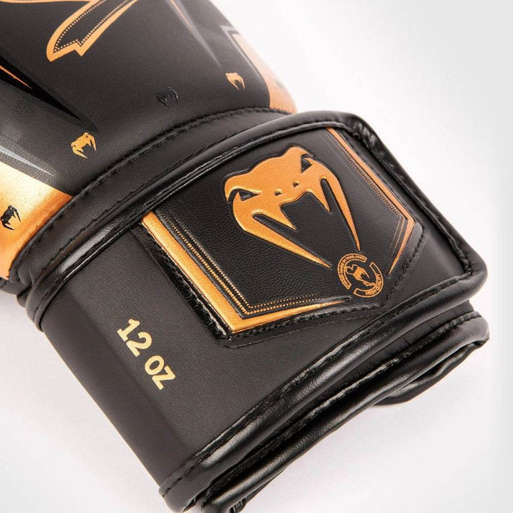 Wrist-strap close-up displaying bronze snake patch on black background.