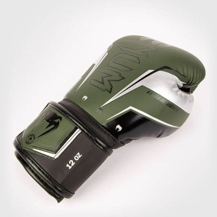 Angled khaki-silver glove lying on side showing full silver “VENUM” print.