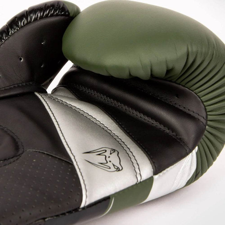 Palm-side ventilation and stitching of khaki-silver glove, thumb folded inward.