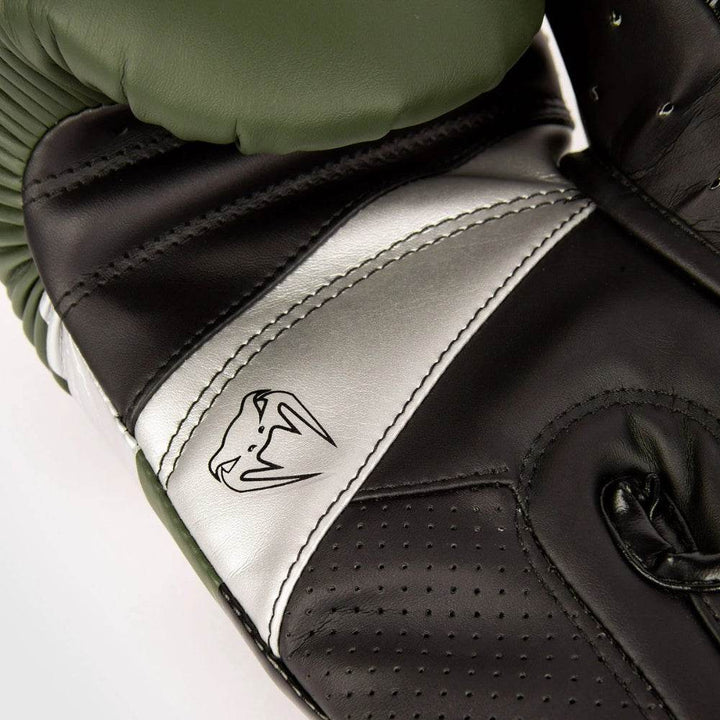 Palm-side ventilation and stitching of khaki-silver glove, thumb folded inward.