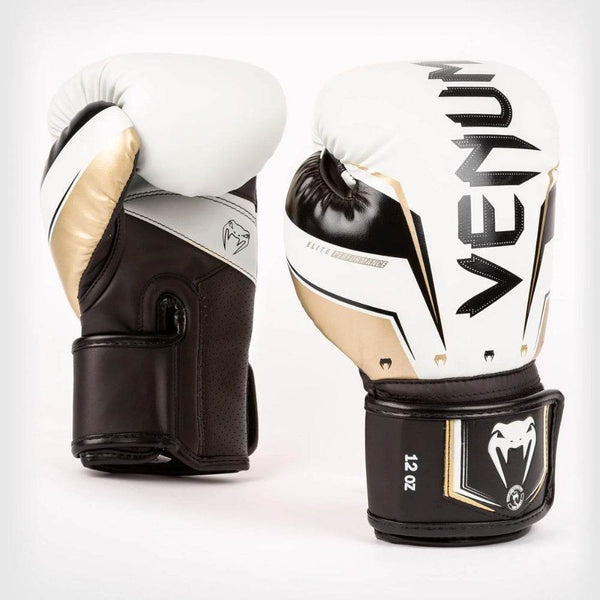 Front & side view of Venum Elite Evo boxing gloves in white-gold, upright, showing large gold “VENUM” logo.