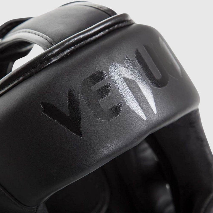 Close-up of embossed black logo on the headgear’s front panel.