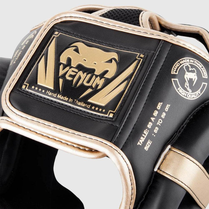 Detailed shot of the rear velcro closure system and decorative Venum logo patch reading “Hand Made in Thailand,” embossed in gold on black leather.