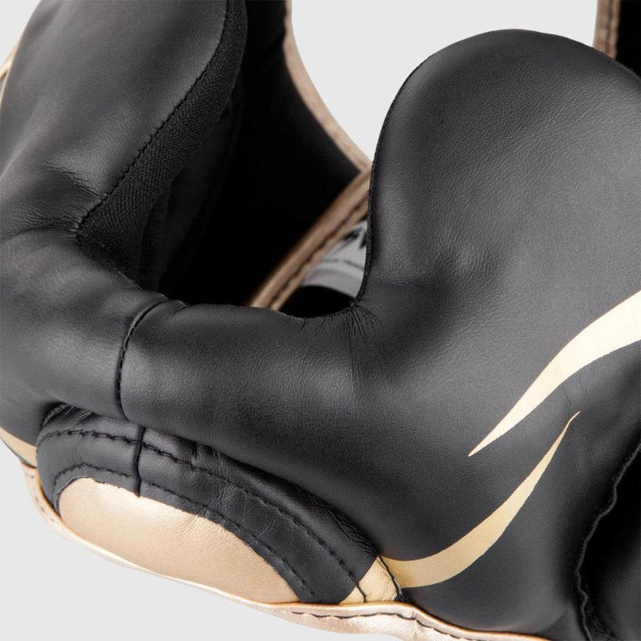 Detailed close-up of the cheek protection area, featuring smooth leather surface with a curved gold streak graphic and strong seamwork.