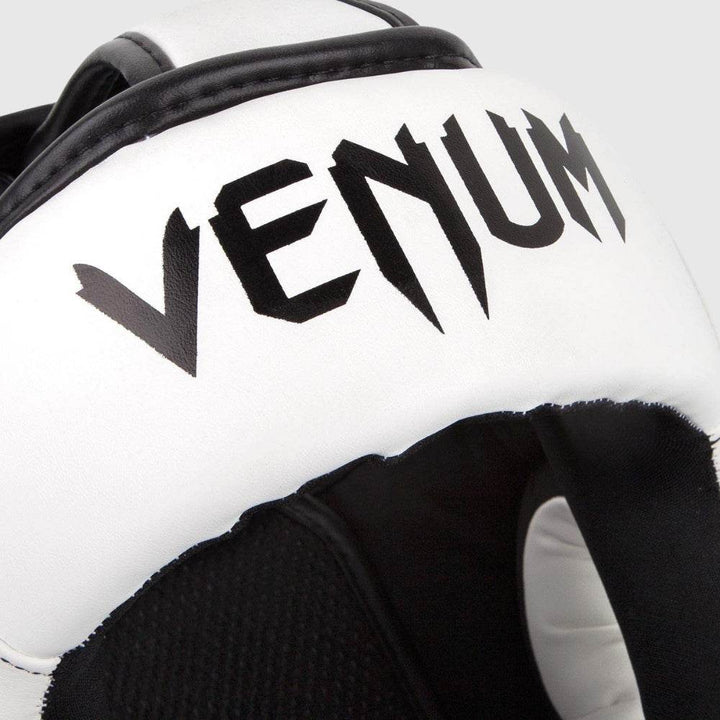 Close-up of forehead showing bold Venum typography on white leather.