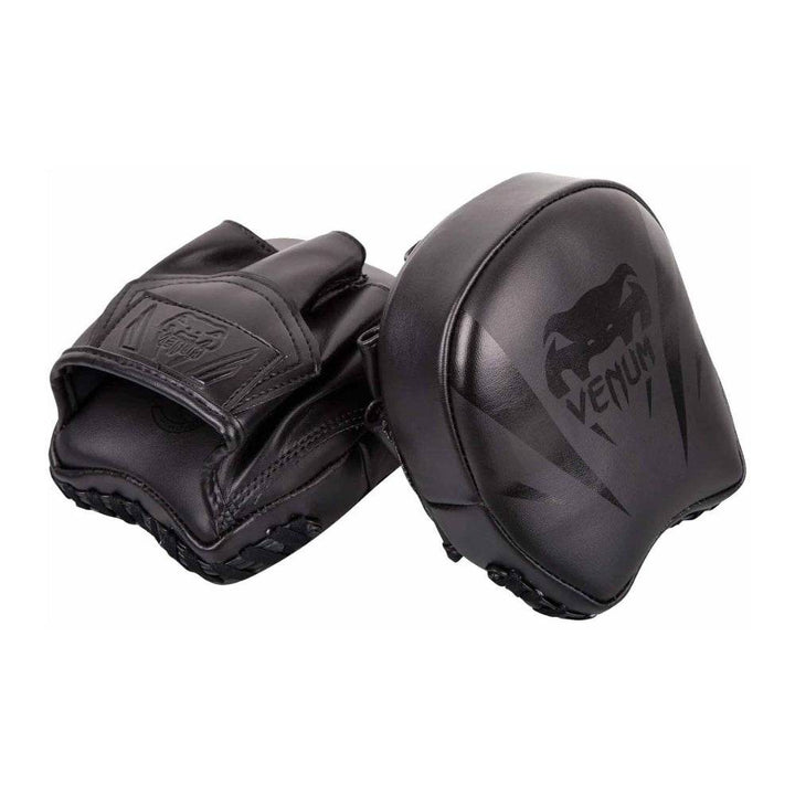 Angled view of Venum Elite Mini Focus Mitts showcasing contoured black leather shell with embossed Venum logo.