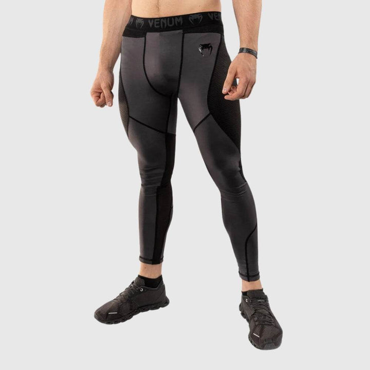 Side-front angled view of the Venum men’s spats showcasing side panel design and Venum logo on waistband.