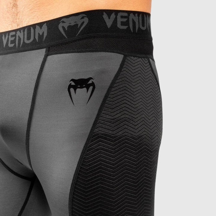 Close-up of the left hip showing the black Venum snakehead logo and textured fabric panel.