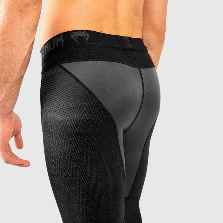 Angled rear close-up view displaying mesh panels and the Venum waistband with logo detail.